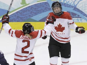 Two hockey players celebrate on the ice.