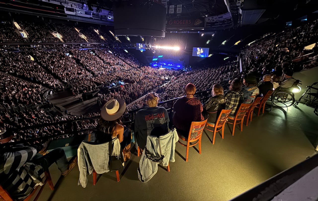 Wide shot of accessible seating area showing people seated in chairs and one wheelchair