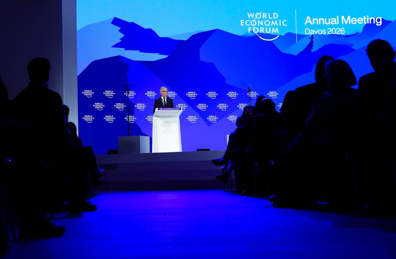 A man stands on a stage in a dark room