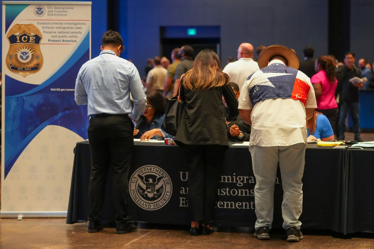 People are checked in during an ICE, Immigration and Customs Enforcement, hiring fair Tuesday, Aug. 26, 2025, in Arlington, Texas. (AP Photo/Julio Cortez)