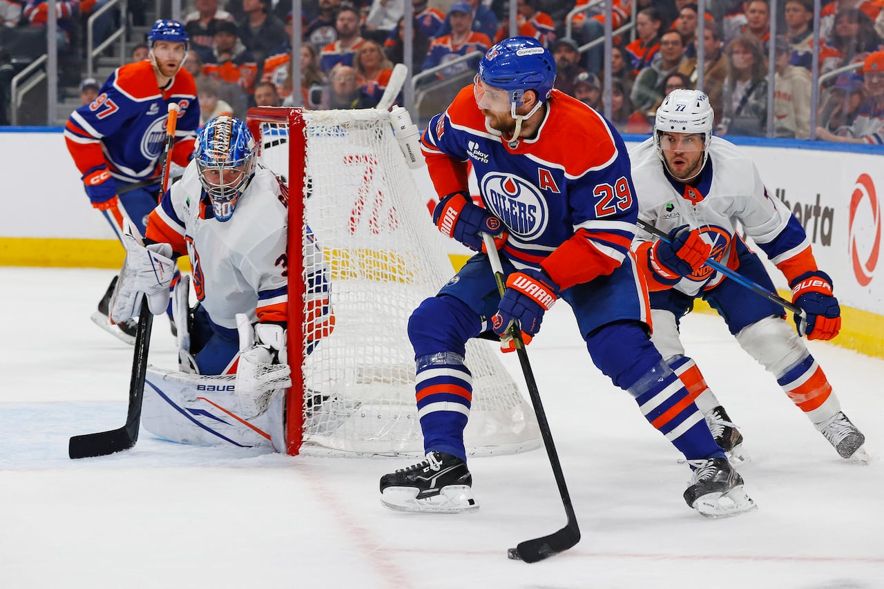 An Edmonton Oilers hockey player skates with the puck.