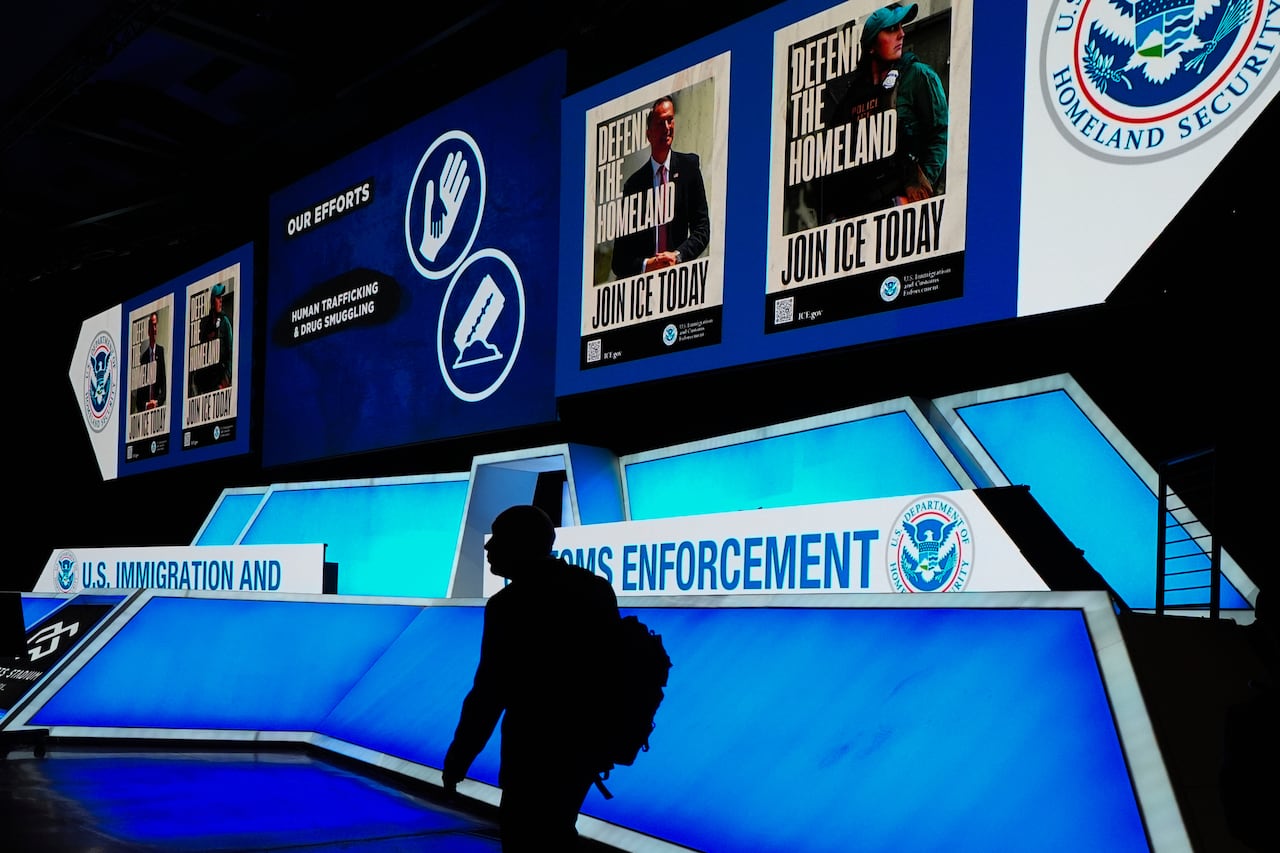 FILE - A person walks near the stage during an Immigration and Customs Enforcement (ICE) hiring fair in Arlington, Texas, on Tuesday, Aug. 26, 2025. (AP Photo/Julio Cortez, File)