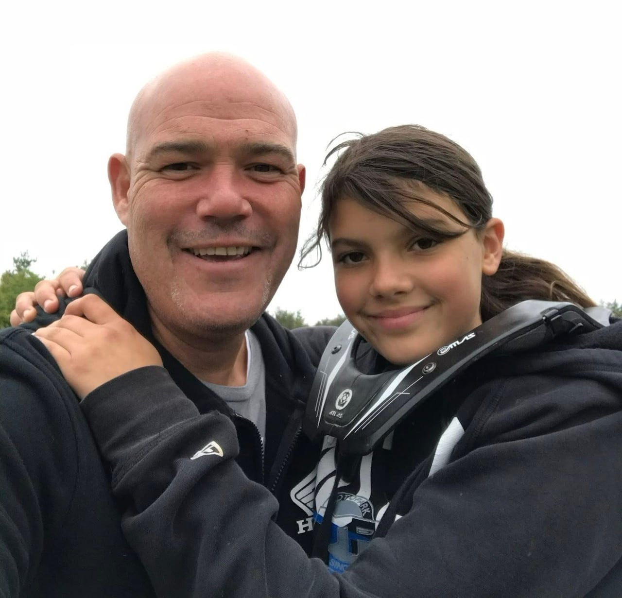 A man and a girl hug