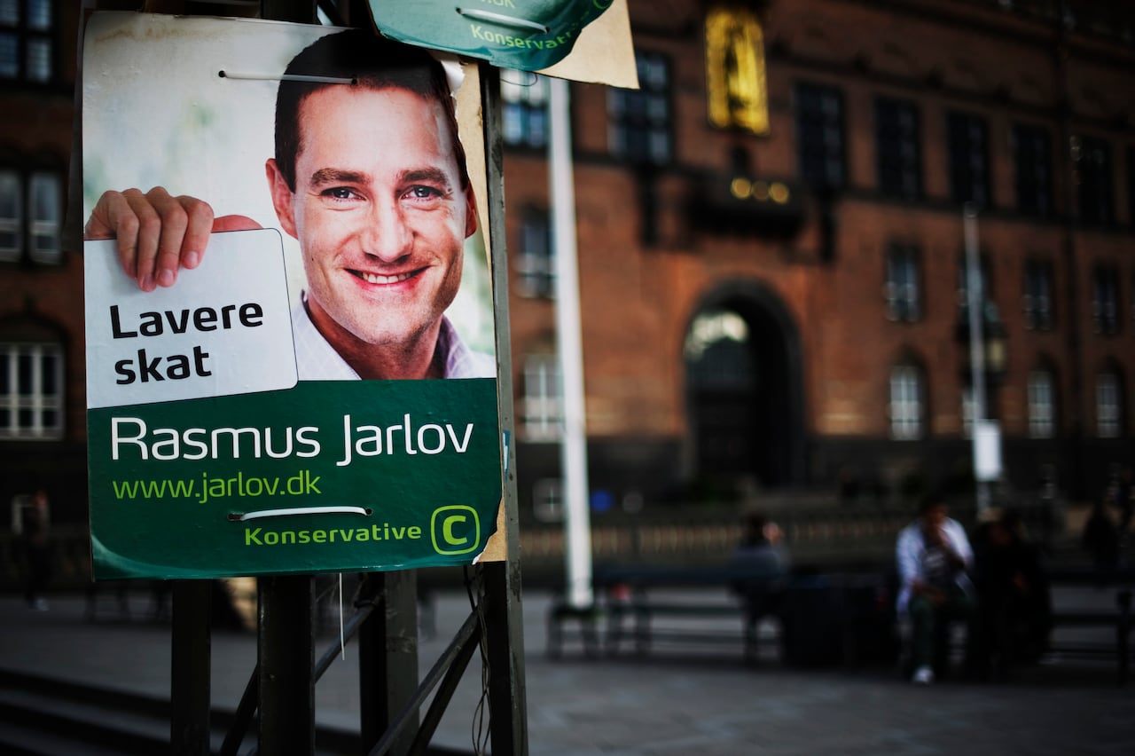 A campaign poster is seen affixed to a pole.