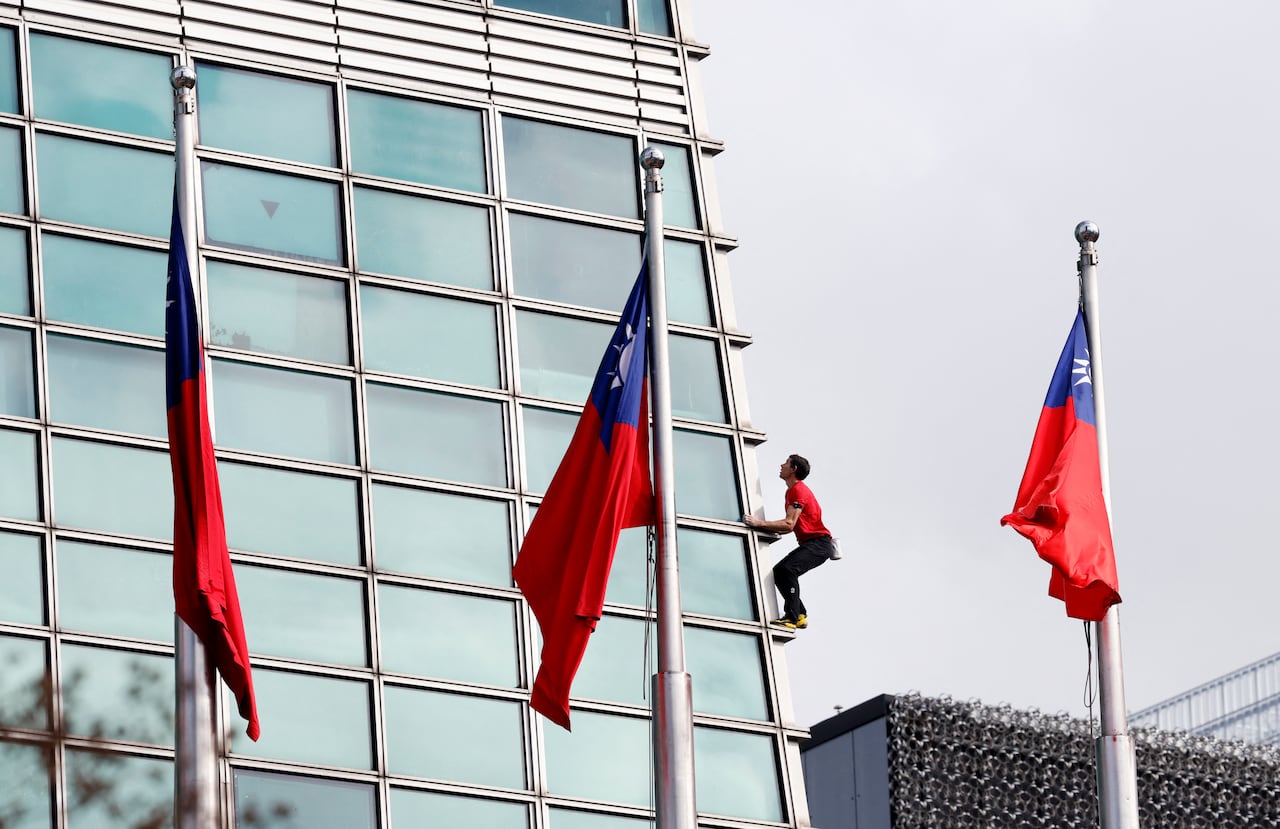 man climbing building